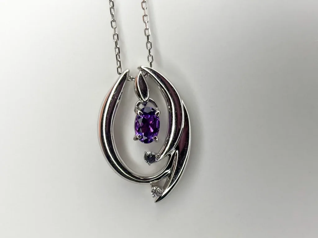 ROSWAYさんのアメシスト、グレースピネル、ダイヤのネックレスを室内でアップで撮ったもの。夜だったので落ち着いたトーンの写真になりました